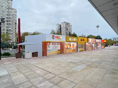 Vibrant Commercial Street With Modern Shops Paved Square Outdoor Seating And High Rise Buildings 3d model