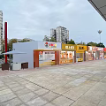 Vibrant Commercial Street With Modern Shops Paved Square Outdoor Seating And High Rise Buildings