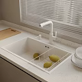 Kitchen Sink With White Faucet Wooden Cutting Board Lemons And Stacked Bowls