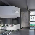 Modern Clothing Store With Giant Blue Eye Art Installation And Gray Interior Design