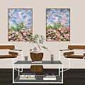 Modern Living Room With Floral Paintings Two Chairs Glass Coffee Table Vase And Books
