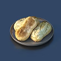 Two Loaves of Golden Crusty Freshly Baked Bread on a Round Plate
