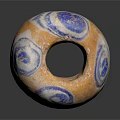 Hand Carved Circular Sculpture With Orange Blue Spiral Patterns And Hollow Center Design