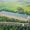 Large Industrial Factory Building With Blue Roof In Open Green Fields And Trees