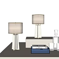 Two Table Lamps with Marble Bases White Fabric Shades on Table with Glassware Decorative Box
