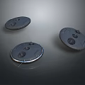 Three Circular Metallic Components With Holes And Raised Parts On Dark Background