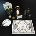 Elegant Tableware Combination with Gold Trimmed Plates Utensils White Roses Candles Glassware on Black Tablecloth