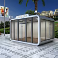 Modern Security Booth With Glass Walls On Plaza Near Green Plants And Street Lamp