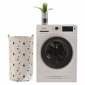 Siemens Front Load Washing Machine With Patterned Laundry Basket And Green Plant Vase