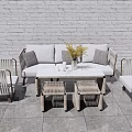 Outdoor Sofa with White and Grey Cushions by White Brick Wall and Grey Slate Floor