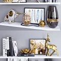 Decorative Ornament Set With Golden Deer Candle Holders Feather Art Frames And Books On Shelf