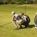 Two Men Playing Golf Together On Golf Course With Clubs