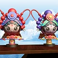 Cartoon Style Sculptures With Red Purple Opera Headdresses On Wooden Table