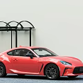 Red Two Door Sports Car With Streamlined Design And Black Wheels Near Shelter