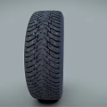 Car Tire With Black Tread Pattern And Silver Alloy Rim Design