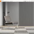 Gray Leather Lounge Chair With Metal Legs Against Vertical Slat Wall And Geometric Rug