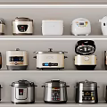 Modern Stylish Rice Cookers And Pressure Cookers As Kitchen Appliances On Shelves