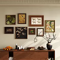 Framed Botanical Paintings as Wall Decor with Vase Oranges Candles and Books