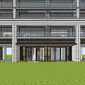 Modern Main Entrance Gate Featuring Glass Doors Outdoor Lighting and Landscaped Lawn with People Walking