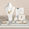 Elegant Jewelry Display With Gold Necklace Rings Bracelets And Earrings On Stand