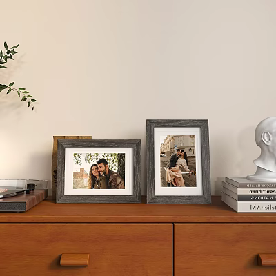 Photo Frames With Portrait Photos On Wooden Cabinet Near Books White Sculpture And Plant 3d model