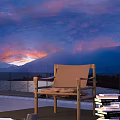 Outdoor Leisure Chair with Metal Frame and Canvas Seat Enjoying Sunset Over Mountain and Lake View