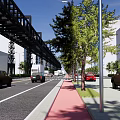 Road Infrastructure Featuring Wide Road Yellow Double Solid Lines Vehicles Street Lamps Trees And Viaduct