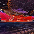Grand Conference Venue With Red Stage Film Elements And Seats