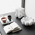 White Inflatable Decorative Ornament On Black Table With Open Book Cups And Books
