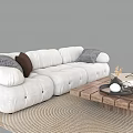White Upholstered Sofa with Pillows and Wooden Coffee Table Set on Woven Rug