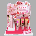 Pink Display Shelf With Cherry Blossom Decoration And Lipsticks Product Display Setup