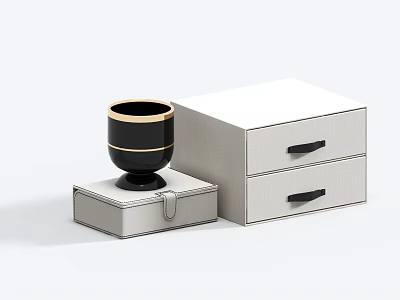 Black Cup With Gold Rim On White Box Next To White Two Drawer Cabinet 3d model
