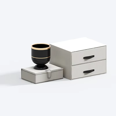 Black Cup With Gold Rim On White Box Next To White Two Drawer Cabinet 3d model