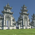 Ornate Traditional Entrance Gate With Intricate Stone Carvings And Tiered Towers Design