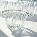 Transparent Glass Water Fountain With Striped Rectangular Curved Circular Structures And Shadow Effects
