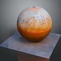 Display of Orange Sphere With Maps and Text on Gray Square Platform