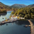 Scenic Lakeside Landscape With Calm Water Green Mountains Lush Trees Wooden Pier And Lighthouse