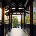 Red Lanterns With Golden Tassels Hanging Under Traditional Wooden Building Eaves