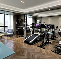 Modern Spacious Home Gym With Treadmill Exercise Bikes And Wooden Flooring