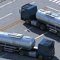 Two Blue Cab Silver Tanker Trucks In Parking Lot With White Lines