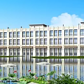 Modern Hotel Building with Water Reflection in Front and Lotus Flowers Among Green Plants