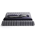 Modern Tufted Bed With Pleated Skirt And Navy Bedding