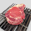 Fresh Ribeye Beef Steak On Black Grill With Juicy Red Meat And Fat
