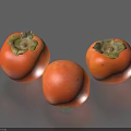 Three Ripe Fresh Orange Persimmons with Green Calyx on Grey Surface