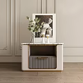 Modern Bedside Table With Gold Accents Green Plant White Vases And Framed Sculpture Artwork On Paneled Wall
