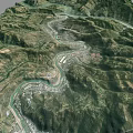 Aerial View Of Mountainous Landscape With Winding River And Village Valley