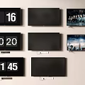 Multiple Wall Mounted TVs with Digital Clocks Black Screens and Movie Content