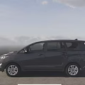 Black Toyota MPV Exterior Design On Scenic Road With Clear Sky