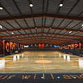 Spacious Basketball Court With Wooden Floor Ceiling Lights And Decorative Walls