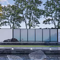 Modern Feature Wall With Glass Panels Lush Trees Water Feature And Stone Paving